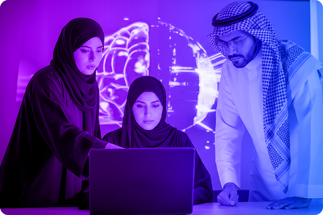 A team of professionals working on a laptop in a neon-lit office
